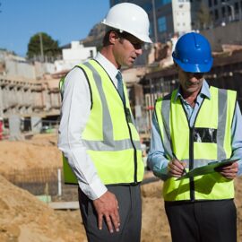 Mature men meeting on construction site